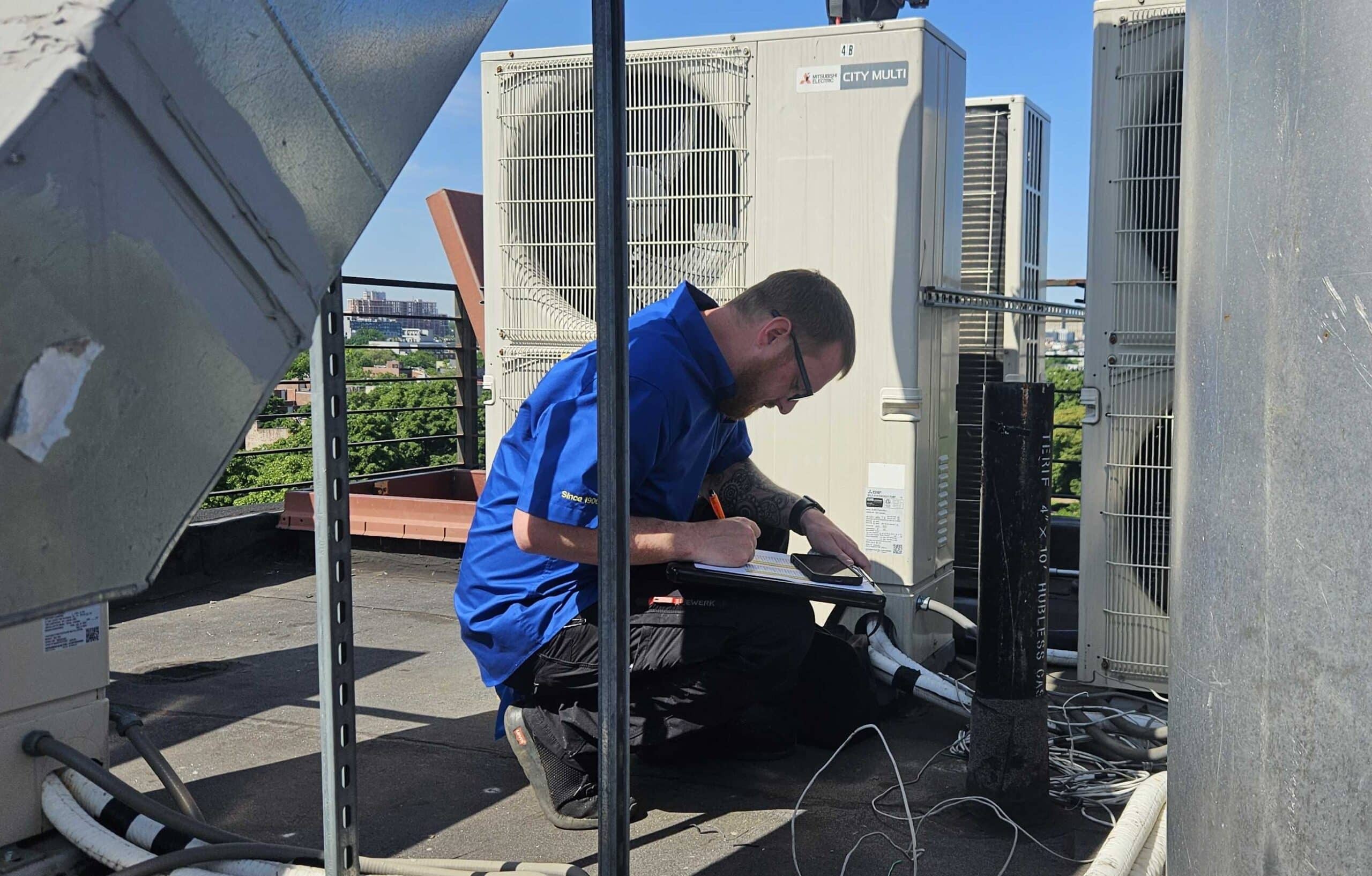 Petri tech working on an air conditioner in Brooklyn