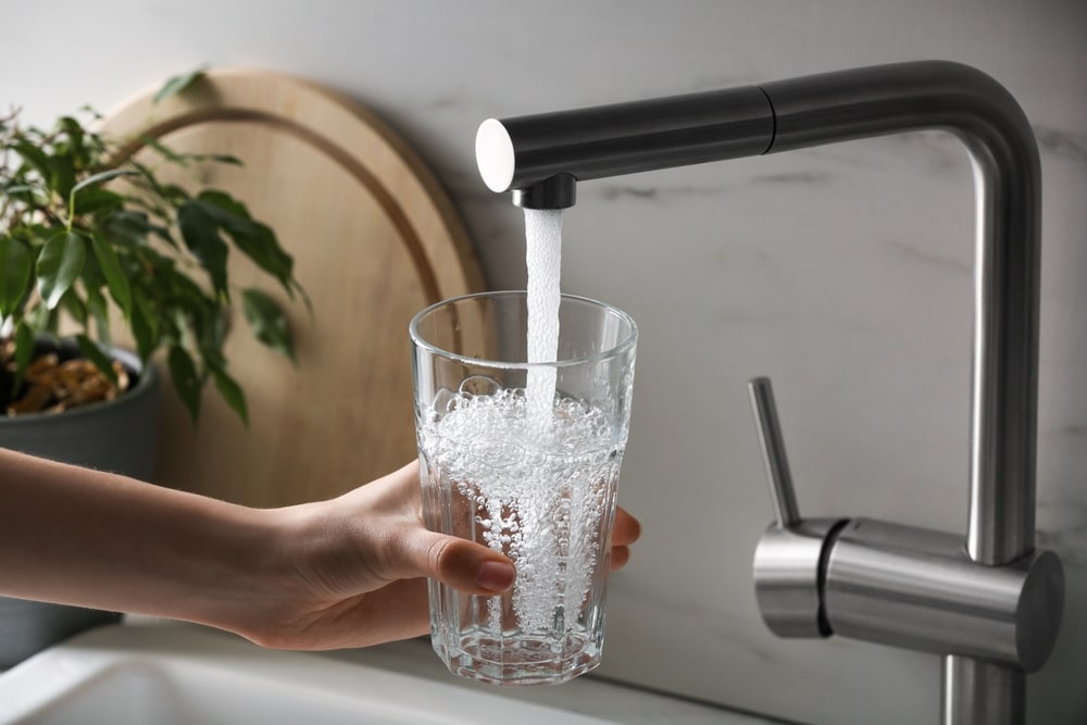 filling up glass with water from tap