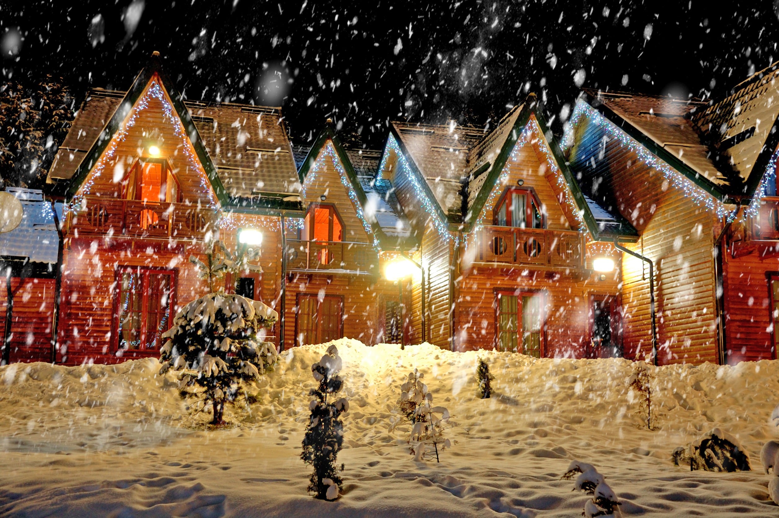 home with lights for the holidays in the snow.