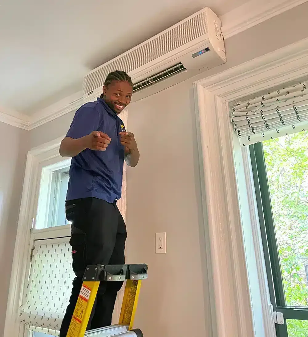 A Petri Technician performing maintenance on a ductless HVAC unit in Brooklyn, NY.