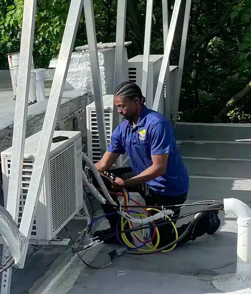 Petri Technician working on an HVAC unit in Brooklyn, NY.