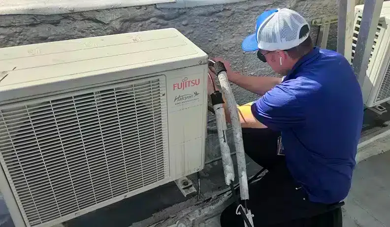 Petri Technician working on an HVAC unit in Brooklyn, NY.