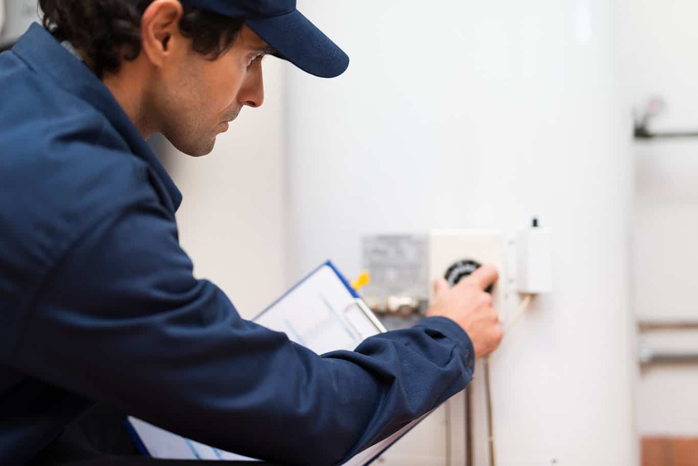 plumber performing water heater maintenance in brooklyn