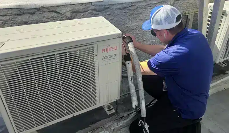 Petri Technician working on an HVAC unit in Brooklyn, NY.