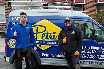 plumbers and hvac technicians in front of pluming van in brooklyn or queens, NY
