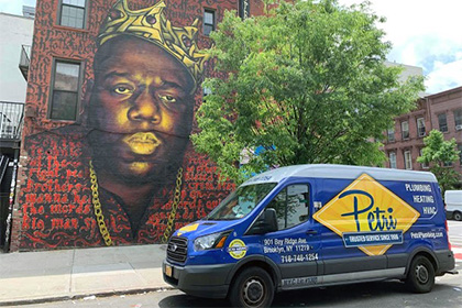 technicians standing in front of plumbing and HVAC van in Queens, NY