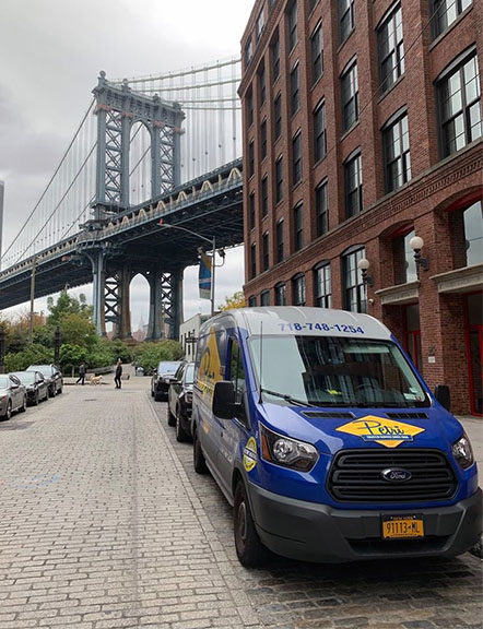 brooklyn plumbing van in front of brownstone building