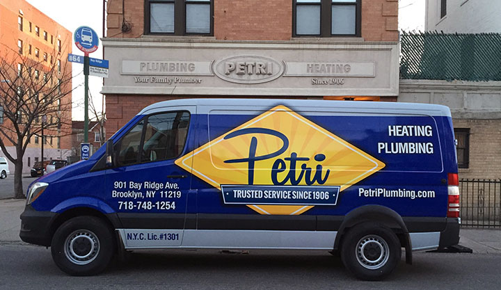 technicians standing in front of plumbing and HVAC van in Queens, NY